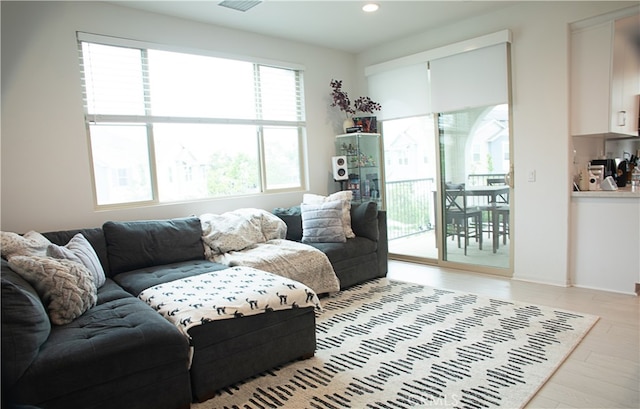 living room featuring light wood-type flooring and recessed lighting