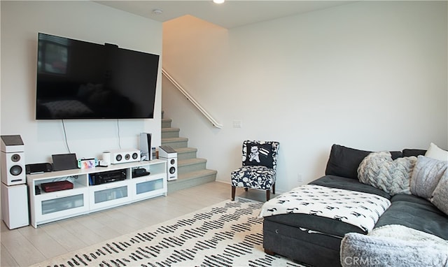 living room featuring light wood-style floors and stairway