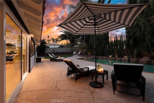 26351 Tarrasa Ln, Mission Viejo, CA 92691 - patio terrace at dusk featuring an outdoor pool, a fenced backyard, and an outdoor living space