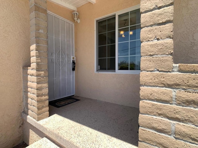 view of exterior entry with stucco siding