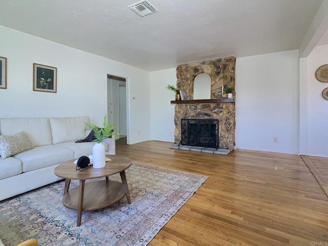 living area with wood finished floors and a fireplace