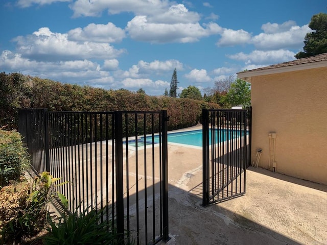 view of pool featuring a patio area and fence