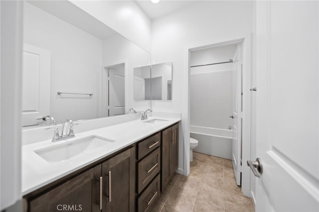 bathroom with toilet, double vanity,  shower combination, and tile patterned floors