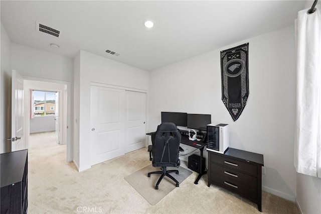 office space featuring light carpet and baseboards