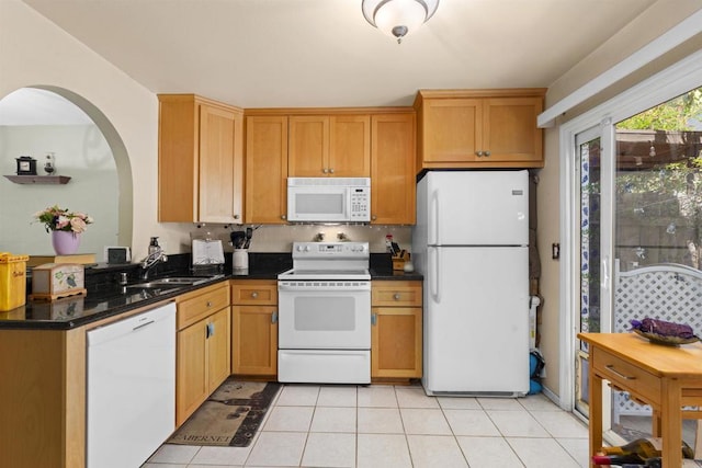 10158 Carefree Dr, Santee, CA 92071 - kitchen with white appliances, a sink, arched walkways, and light tile patterned floors
