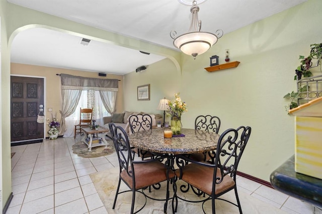 10158 Carefree Dr, Santee, CA 92071 - dining area with arched walkways, light tile patterned flooring, and baseboards