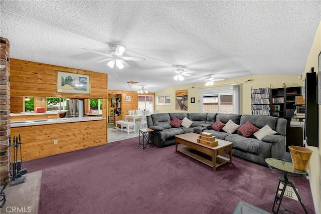 1005 E Woodland Ln, Glendora, CA 91741 - carpeted living room featuring healthy amount of natural light, a ceiling fan, a textured ceiling, and wooden walls