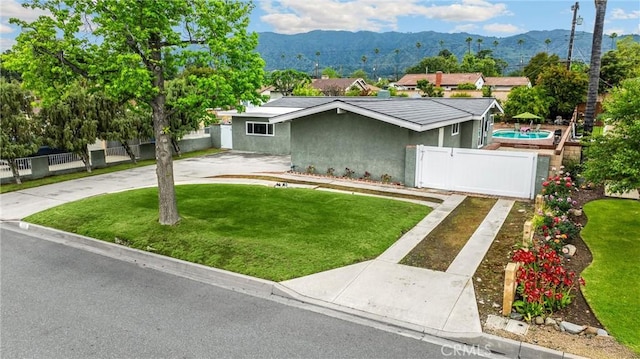 1005 E Woodland Ln, Glendora, CA 91741 - view of front of house with a mountain view, a gate, stucco siding, and concrete driveway