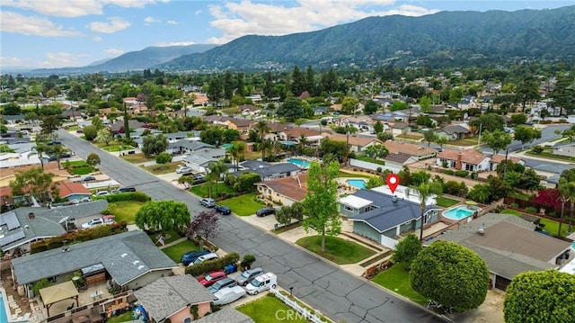 1005 E Woodland Ln, Glendora, CA 91741 - aerial perspective of suburban area with a mountainous background and a pool