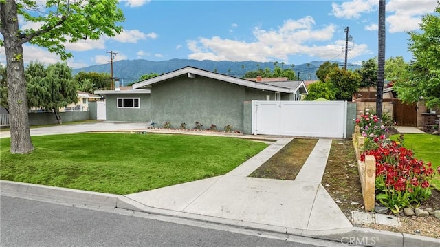 1005 E Woodland Ln, Glendora, CA 91741 - view of front of property with a mountain view, a gate, and stucco siding
