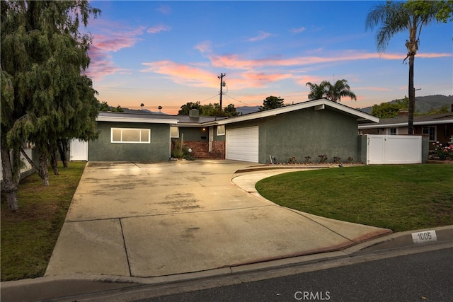 1005 E Woodland Ln, Glendora, CA 91741 - mid-century inspired home featuring stucco siding, a garage, and concrete driveway