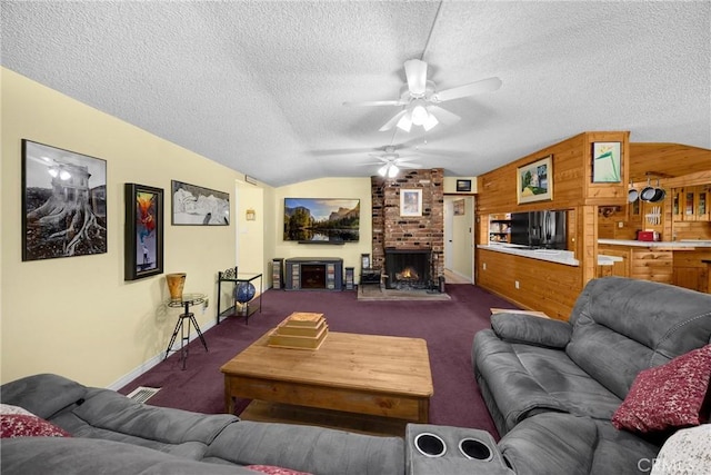 1005 E Woodland Ln, Glendora, CA 91741 - living area featuring vaulted ceiling, ceiling fan, dark carpet, a textured ceiling, and a fireplace