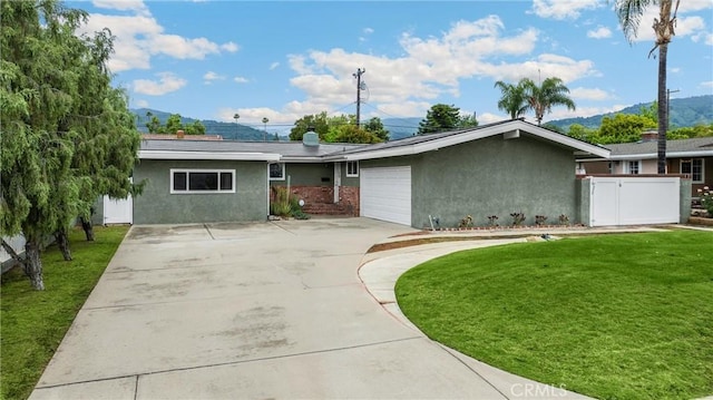 1005 E Woodland Ln, Glendora, CA 91741 - view of front of home with stucco siding, concrete driveway, an attached garage, a mountain view, and a chimney