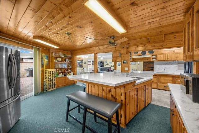 1005 E Woodland Ln, Glendora, CA 91741 - kitchen featuring stainless steel appliances, wood ceiling, a sink, light carpet, and ceiling fan