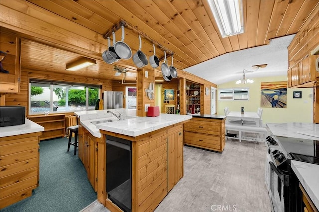 1005 E Woodland Ln, Glendora, CA 91741 - kitchen featuring black appliances, a sink, a center island with sink, vaulted ceiling, and wood ceiling