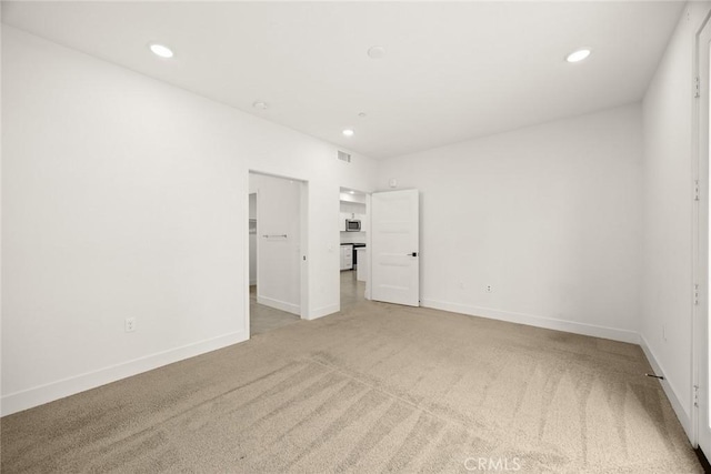 16321 Dawn Way Unit 108, Tustin, CA 92782 - unfurnished bedroom featuring light carpet, recessed lighting, a walk in closet, and baseboards