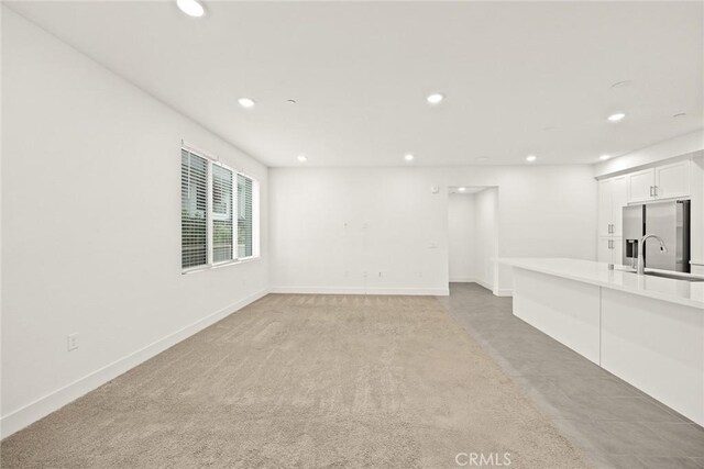 16321 Dawn Way Unit 108, Tustin, CA 92782 - unfurnished living room featuring recessed lighting, a sink, and baseboards