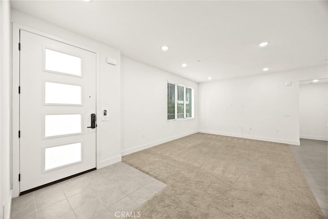 16321 Dawn Way Unit 108, Tustin, CA 92782 - entryway with recessed lighting, light tile patterned floors, baseboards, and light colored carpet