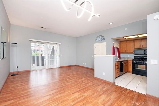776 E San Bernardino Rd Unit 3, Covina, CA 91723 - kitchen featuring black appliances, light wood-type flooring, baseboards, and brown cabinets