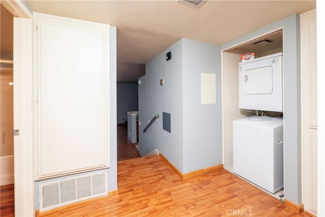 776 E San Bernardino Rd Unit 3, Covina, CA 91723 - laundry room featuring stacked washer / drying machine, light wood-style floors, and baseboards