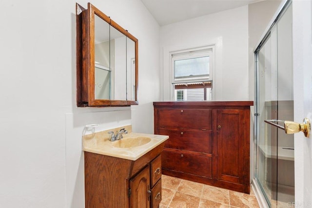 bathroom featuring a stall shower, vanity, and stone finish floors