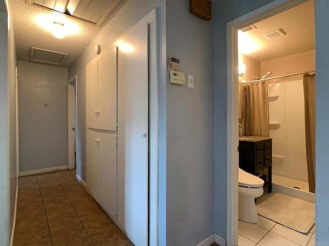9884 Settle Rd, Santee, CA 92071 - hallway featuring tile patterned flooring, attic access, and baseboards
