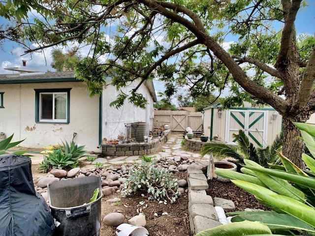 9884 Settle Rd, Santee, CA 92071 - view of yard with fence, a storage unit, a gate, and an outdoor structure