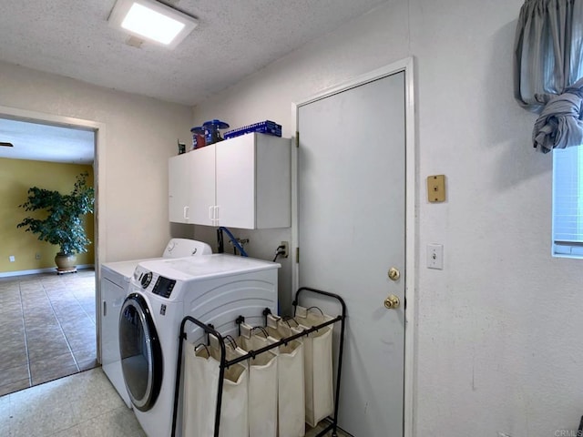 9884 Settle Rd, Santee, CA 92071 - laundry room featuring cabinet space, washer and clothes dryer, a textured ceiling, and light tile patterned flooring