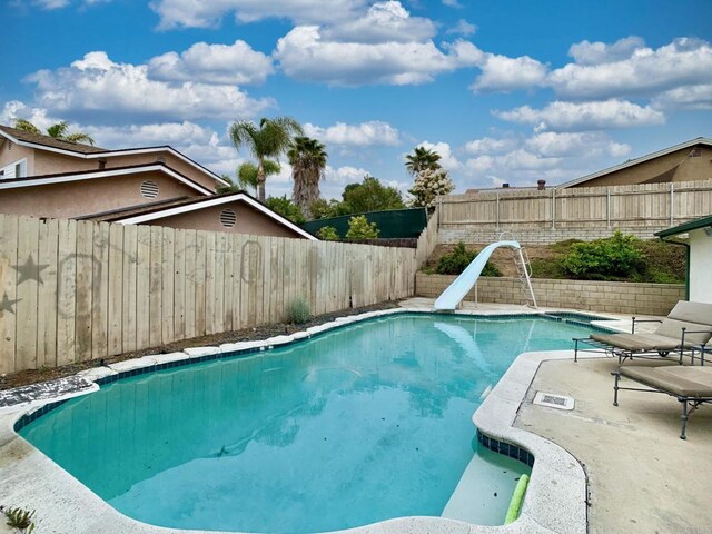 9884 Settle Rd, Santee, CA 92071 - view of pool featuring a water slide and a fenced backyard