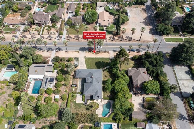 view of property location with a pool area and nearby suburban area