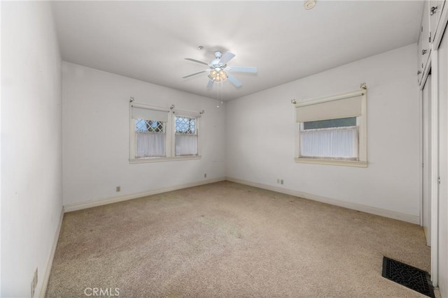 unfurnished bedroom featuring carpet flooring, baseboards, and ceiling fan