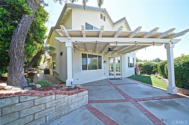 back of property featuring french doors, a patio area, and stucco siding