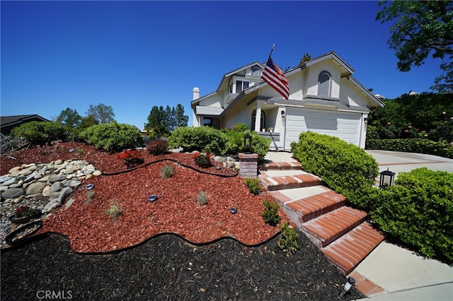 view of front of house featuring stucco siding, a garage, and a chimney