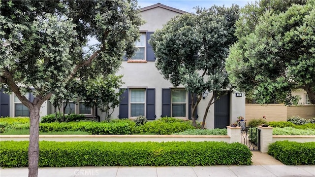 38 Upperbend, Irvine, CA 92618 - obstructed view of property with stucco siding, a fenced front yard, and a gate