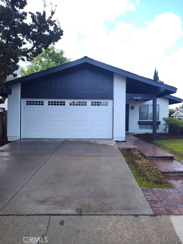 26702 Via Linares, Mission Viejo, CA 92691 - view of front of property featuring concrete driveway, a garage, and stucco siding
