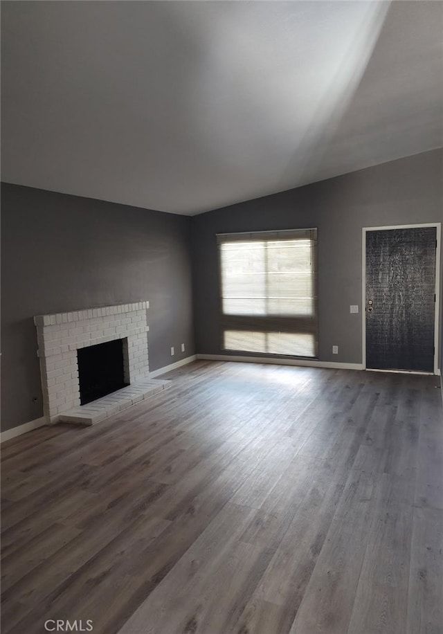 26702 Via Linares, Mission Viejo, CA 92691 - unfurnished living room featuring vaulted ceiling, wood finished floors, baseboards, and a fireplace