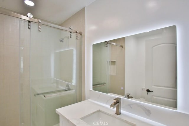 full bath featuring a stall shower and vanity