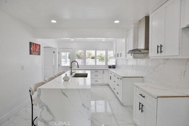 15132 Kornblum Ave, Lawndale, CA 90260 - kitchen featuring a sink, wall chimney exhaust hood, light stone countertops, light marble finish flooring, and recessed lighting