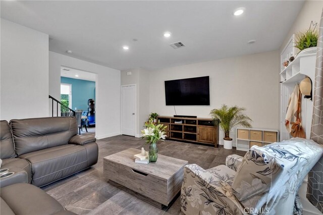 living room with recessed lighting and baseboards