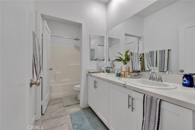 full bath with toilet, double vanity, and shower / tub combination