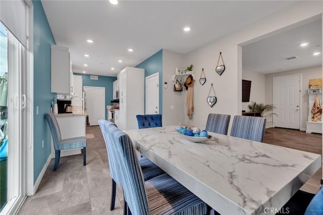 dining space featuring baseboards and recessed lighting