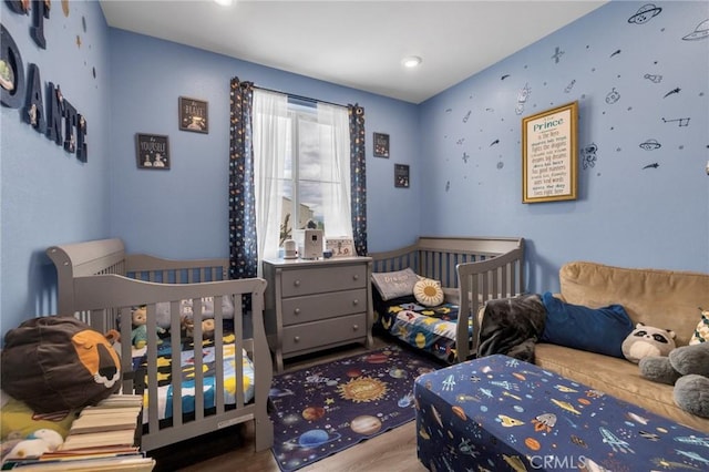 bedroom with wood finished floors and recessed lighting