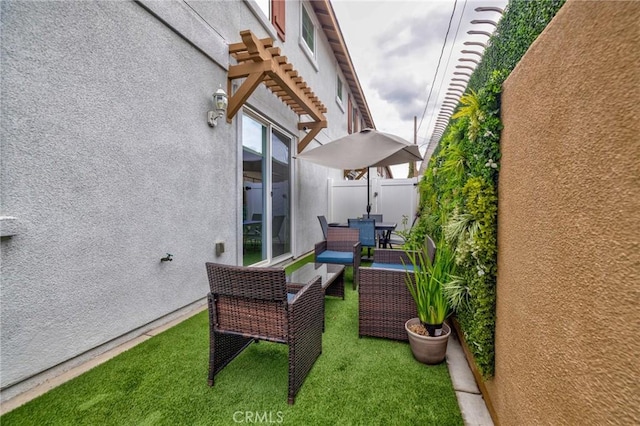 view of patio featuring fence, a pergola, and outdoor lounge area