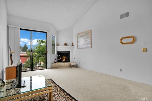 living room featuring carpet floors, vaulted ceiling, and a warm lit fireplace
