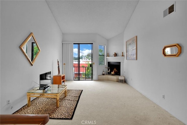 living room with carpet, lofted ceiling, and a warm lit fireplace