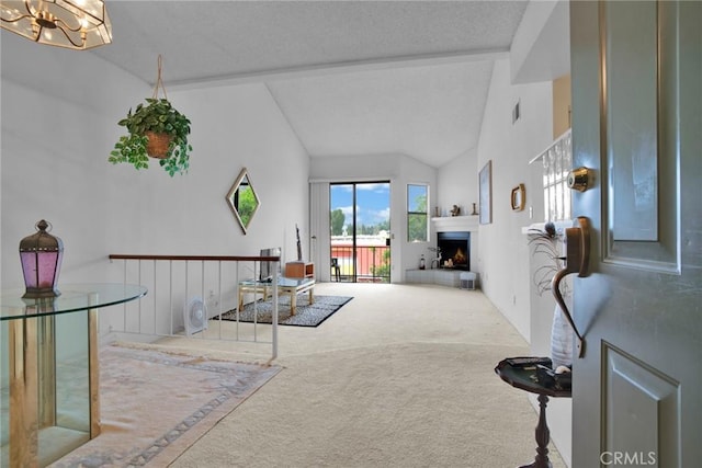 living room featuring carpet floors, a warm lit fireplace, a textured ceiling, a chandelier, and lofted ceiling