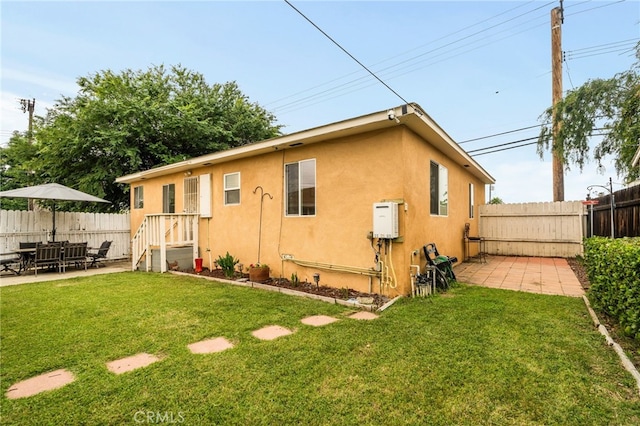 rear view of house with stucco siding and a patio