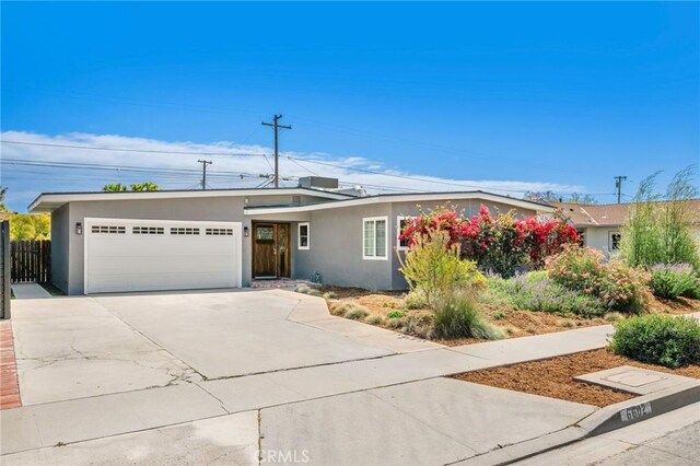 6602 E Wardlow Rd, Long Beach, CA 90808 - ranch-style home featuring stucco siding, an attached garage, concrete driveway, and fence
