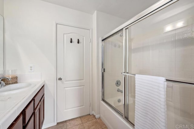 bathroom with shower / bath combination with glass door and vanity