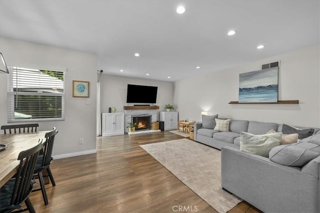 3821 W 183rd St, Torrance, CA 90504 - living room with wood finished floors, a warm lit fireplace, baseboards, and recessed lighting